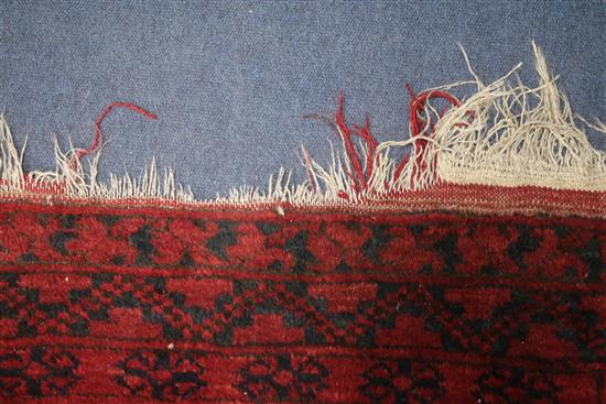 An Afghan red ground rug, 235 x 340cm